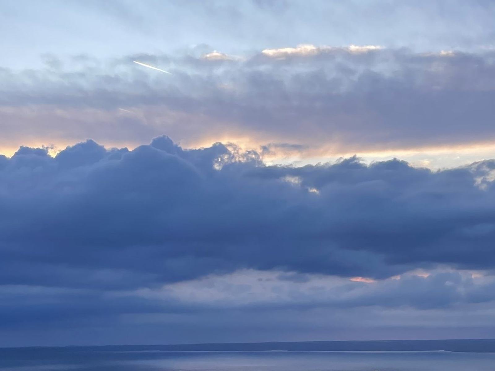 Dark cloud over the sea at dusk